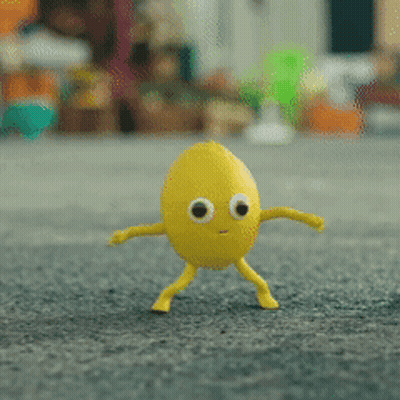 Yellow Egg With Big Eyes And Legs Standing On Carpet GIF