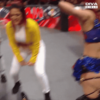 Yellow Jacket Woman Dancing With Blue Bikini Woman GIF