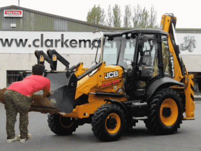 Yellow JCB Tractor In Front Of Building Saying Ww.clarkemg GIF