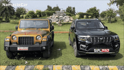 Yellow Jeep And Black SUV Side By Side GIF