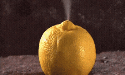 Yellow Lemon With Spray Coming Out Top GIF