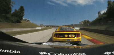 Yellow Race Car Number 22 Driving Down Track GIF
