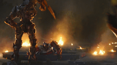 Yellow Robot Fighting Black Robot In Flames GIF