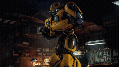 Yellow Robot Standing In Dark Room With Tools GIF