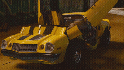 Yellow Robot With Blue Eyes In Building GIF