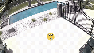 Yellow Smiley Face In Front Of Fence And Pool GIF