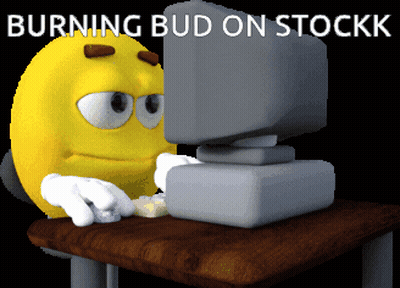 Yellow Smiley Sitting at Computer Burning Bud on Stockk
