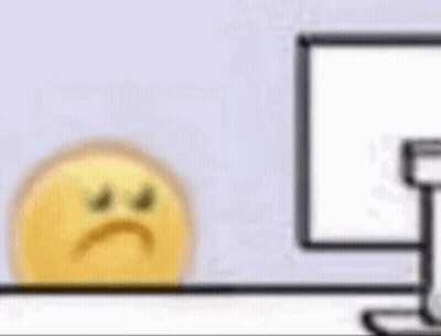 Yellow Smiley Sitting In Front Of Computer GIF