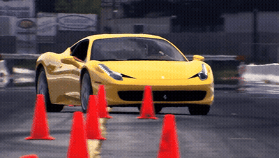 Yellow Sports Car Driving Through Red Cones GIF