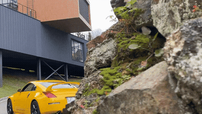 Yellow Sports Car Parked In Front Of Building GIF