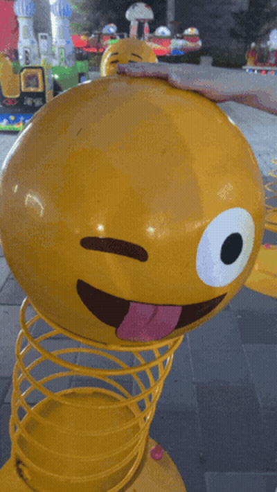 Yellow Spring Toy Smiley Face Sticking Tongue Out