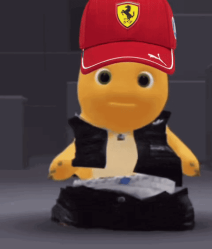 Yellow Stuffed Animal In Red Hat With Ferrari Logo GIF