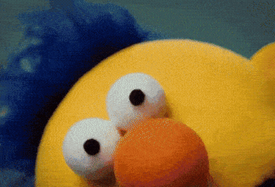 Yellow Stuffed Animal With Big Eyes And Orange Beak GIF