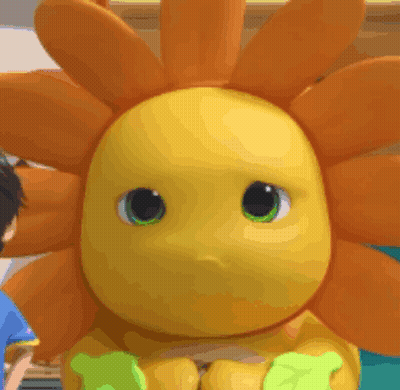 Yellow Stuffed Animal With Green Eyes Beside Child GIF