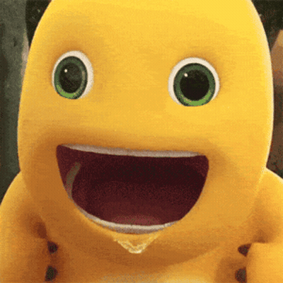 Yellow Stuffed Animal With Green Eyes Smiling With Mouth Open GIF