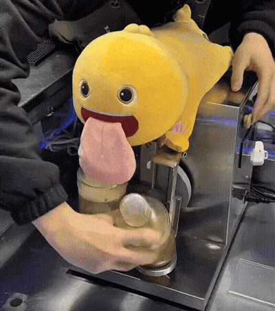 Yellow Stuffed Animal With Tongue Out Poured Into Glass GIF
