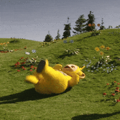 Yellow Teddy Bear Laying In Grass GIF