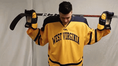 Yellow WV Jersey Man Holding Hockey Stick Overhead GIF