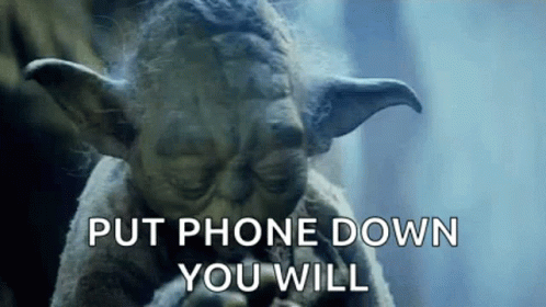 Yoda From Star Wars Is Holding A Cell Phone In His Hand And Says `` Put Phone Down You Will '' . GIF