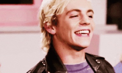 Young Blonde Man In Black Leather Jacket Smiling GIF