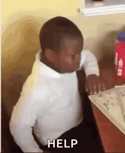 Young Boy At Desk With Eyes Closed And Help On Screen GIF
