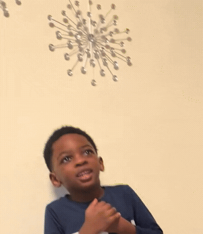 Young Boy At Table With Hands Together GIF