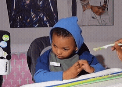 Young Boy Brushing Teeth In Blue Hoodie GIF