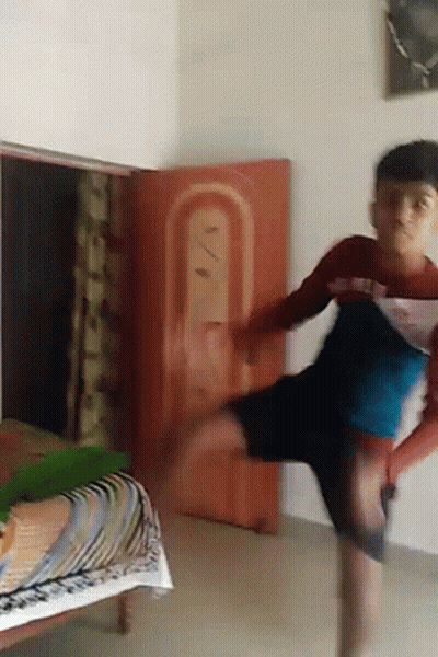 Young Boy Doing Handstand By Red Sign GIF