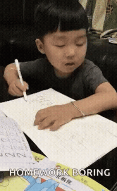 Young Boy Doing Homework At Table GIF