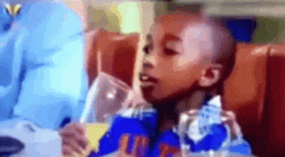Young Boy Drinking From Glass GIF