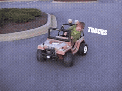 Young Boy Driving Toy Jeep With Trucks GIF