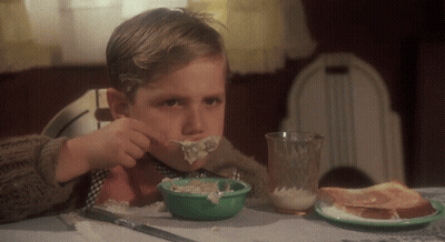 Young Boy Eating Bowl Of Food At Table GIF