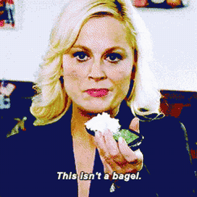 Young Boy Eating Donut With Wow On Shirt GIF