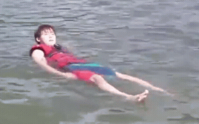 Young Boy Floating On Back In Water GIF