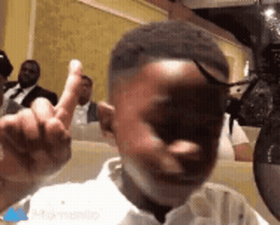 Young Boy Giving Middle Finger At Restaurant GIF