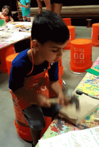 Young Boy Hammering Wood In Front Of Do This Bucket GIF