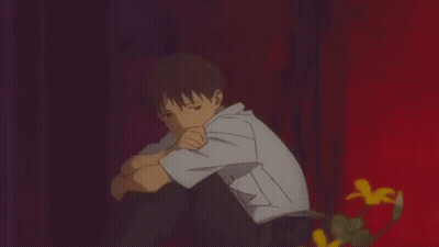 Young Boy Head On Knees Red Wall GIF