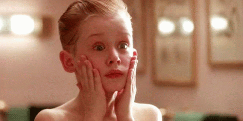 Young Boy Holding Face Looking Surprised GIF