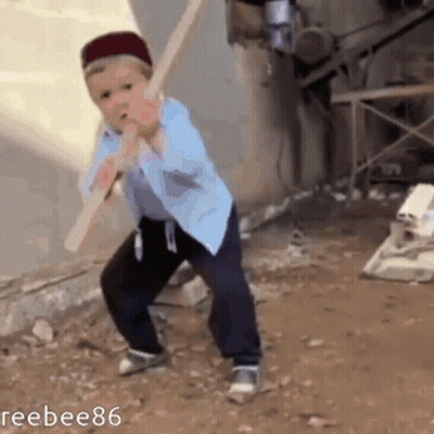 Young Boy Holding Wooden Stick In Mouth GIF