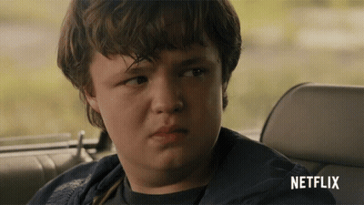 Young Boy In Back Seat Of Car With Netflix Logo GIF