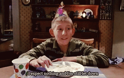 Young Boy In Birthday Hat At Table With Food GIF
