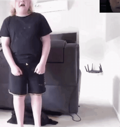 Young Boy In Black Shirt And Shorts By Couch GIF