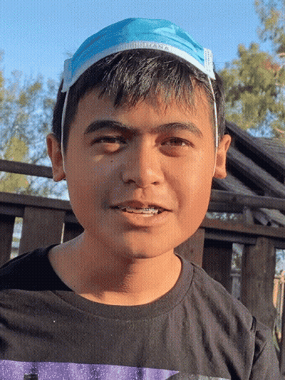 Young Boy In Black Shirt With Blue Face Mask On Head GIF