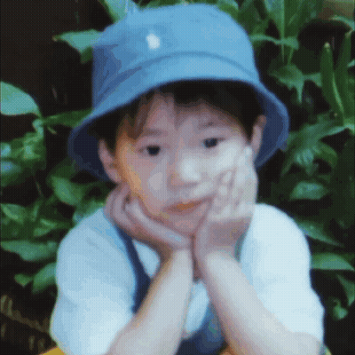 Young Boy In Blue Hat Hand On Face GIF