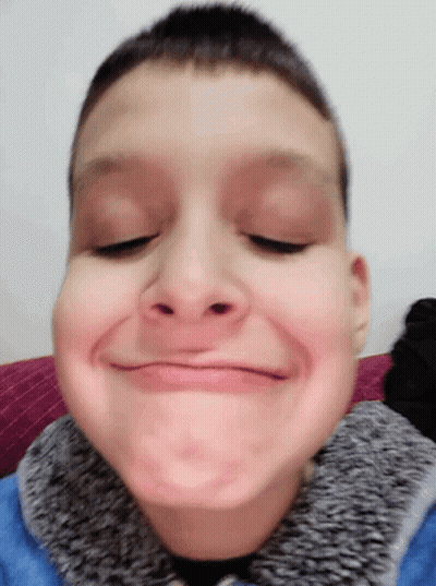 Young Boy In Blue Jacket Making Funny Face GIF