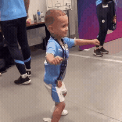 Young Boy In Blue Shirt And Shorts Dancing GIF
