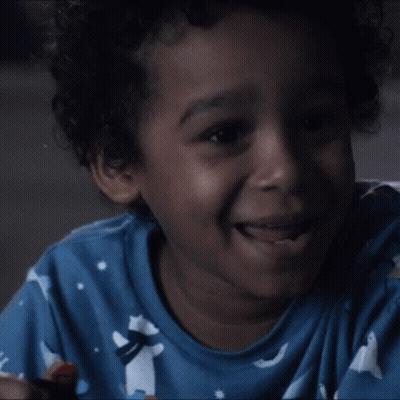 Young Boy In Blue Shirt Laughing Lollipop GIF