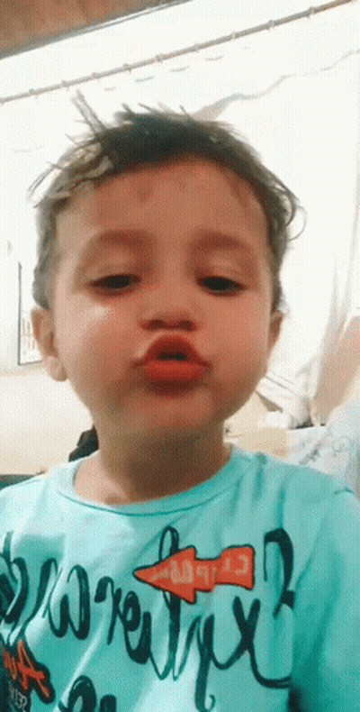 Young Boy In Blue Shirt Making Funny Face GIF