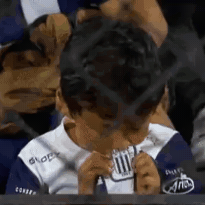 Young Boy In Blue White Shirt Eating Paper GIF