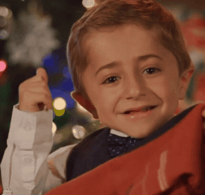 Young Boy In Bow Tie Holding Red Item GIF